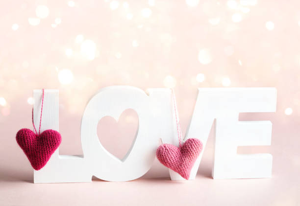 istock Word Love and pink hearts at pink background 1124282021