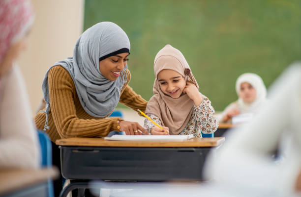 istock Muslim girl learning from teacher 1124283520