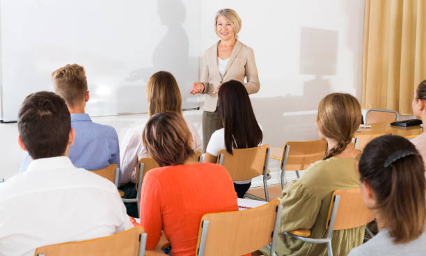 istock Mature female giving presentation for students 1124284915