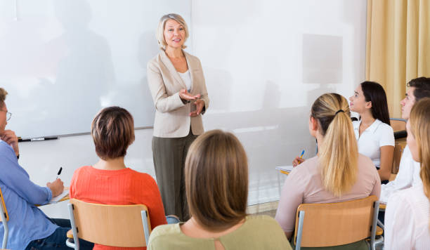 istock Female teacher lecturing to students 1124284939