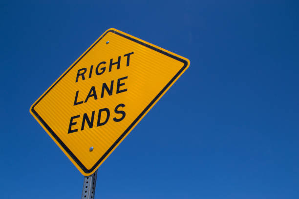 istock Right lane ends street sign 1124287208