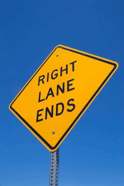 istock Right lane ends street sign 1124287597