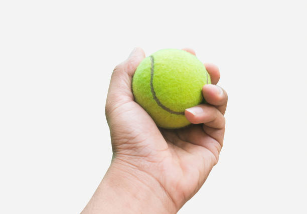 istock tennis in hand isolated on white background 1124289887
