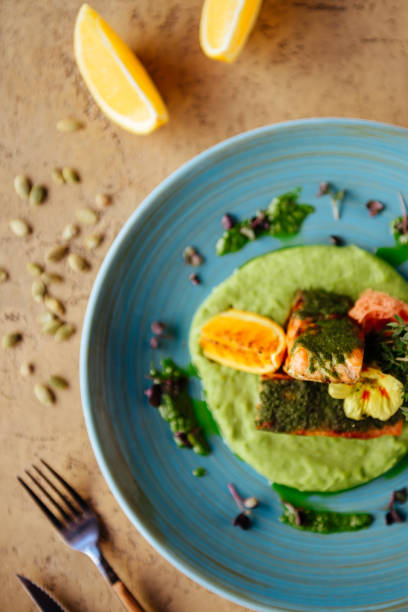 istock Baked salmon garnished with asparagus and tomatoes with herbs. 1124290288