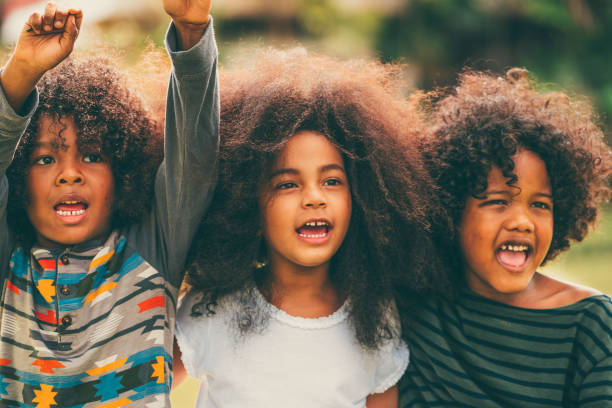 istock Happy kids group playing in the park in school. 1124291672