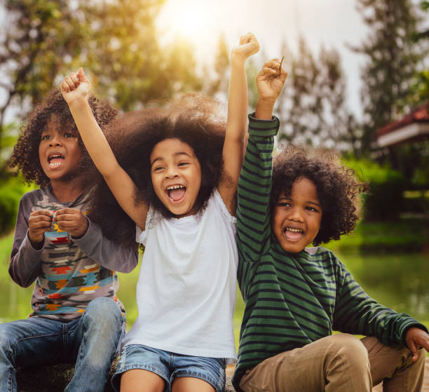 istock Happy kids group playing in the park in school. 1124291681