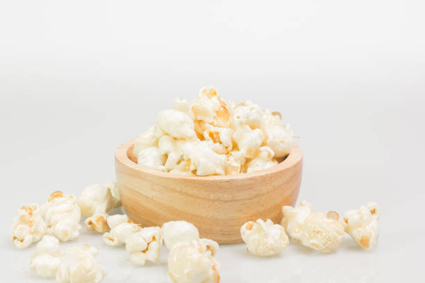 istock popcorn in wooden bowl on white background 1124293794