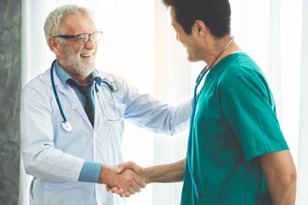 istock Senior male doctor working with another doctor. 1124294945