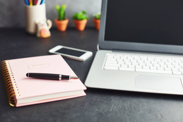 istock Writers desk with note book and accessories 1124296593