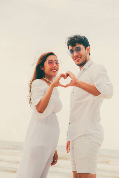 istock Young couple shows heart shape hand gesture. 1124298160