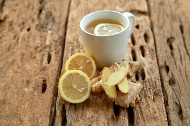 istock Cup of tea with lemon and ginger on a old wooden table 1124299280