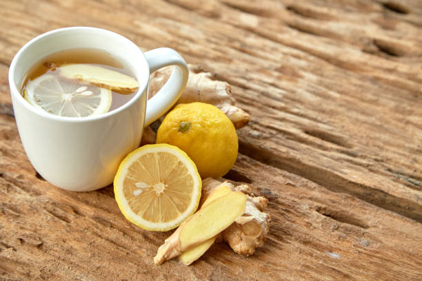 istock Cup of tea with lemon and ginger on a old wooden table 1124299722
