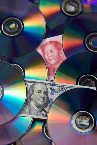 istock DVD with Chinese and US banknotes 1124301038