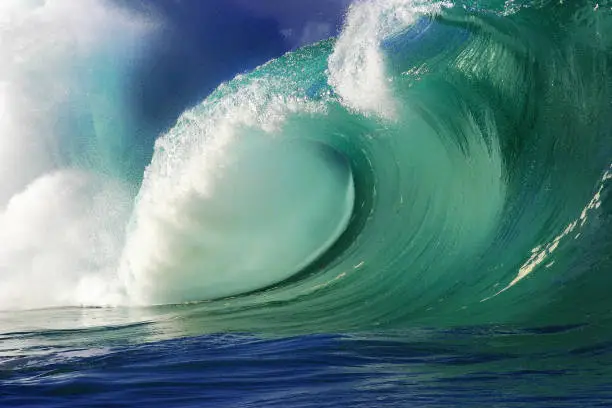 A big wave crashing towards the beach at Waimea Bay on the North Shore of the island of Oahu, Hawaii.