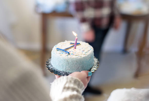 istock Mom holding baby‘s first birthday cake 1124309734