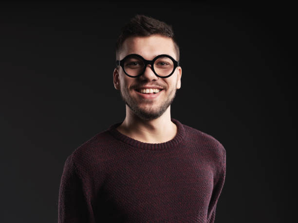 istock Portrait of young man smiling studio shot 1124310033