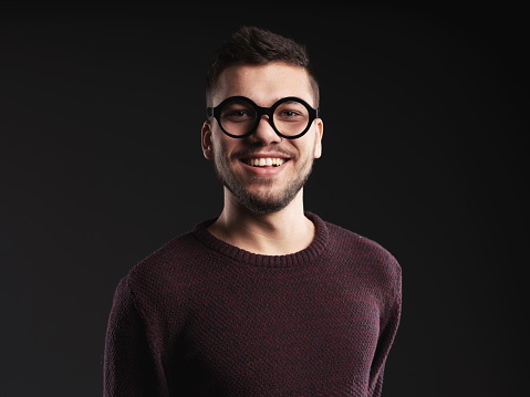 Portrait of young man smiling studio shot.