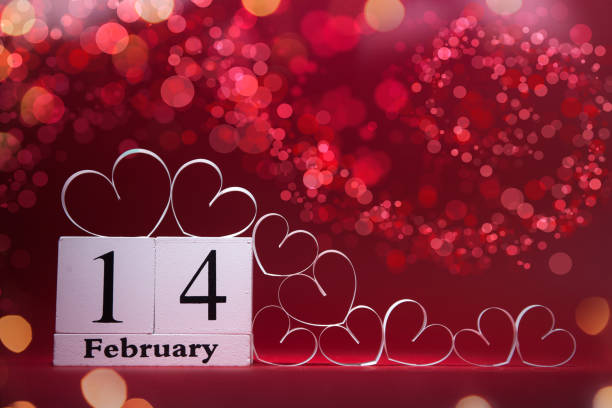 White Hearts and wooden block calendar on red background. Valentines day card. Copy space for your text. stock photo