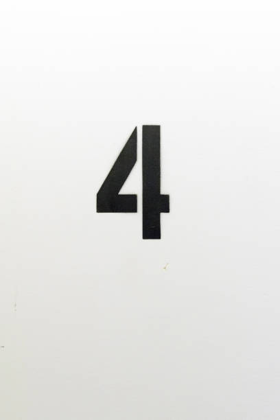 istock Number four stenciled in black paint on white wall 1124311958