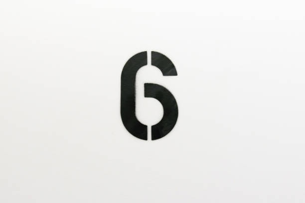 istock Number six stenciled in black paint on white wall 1124311964