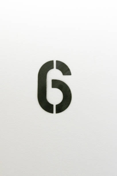 istock Number six stenciled in black paint on white wall 1124311966