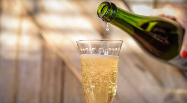 istock Pouring champagne into glass from bottle 1124312404