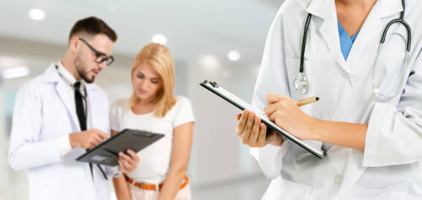 istock Doctor working in hospital with other doctors. 1124312878
