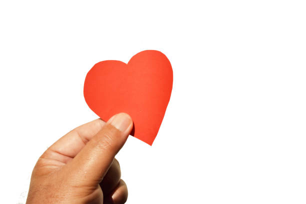 istock Human hand holding a red heart isolated on white background 1124319884