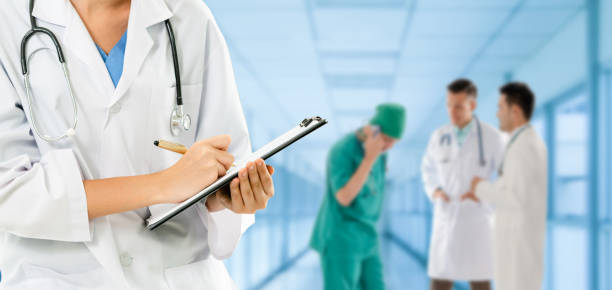 istock Doctor working in hospital with other doctors. 1124323785