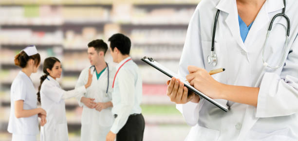 istock Doctor working in hospital with other doctors. 1124323960