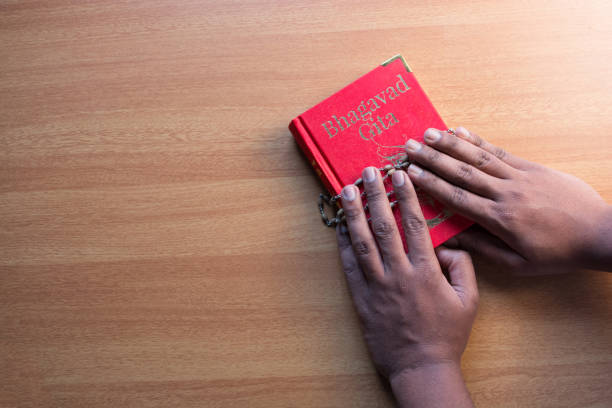 The hand holding book on isolated background