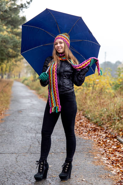 istock young woman walking in an autumn park 1124335833