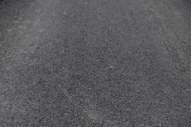 istock Texture of used black asphalt road 1124337833