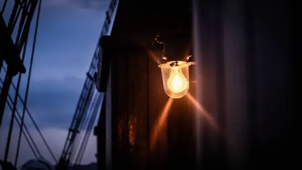 Light up classic bulb from a classic sail ship, night view