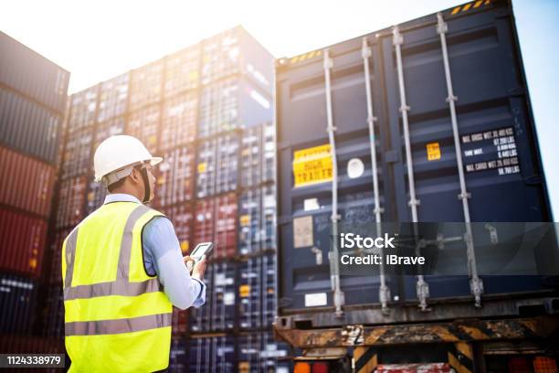 Foreman Control Loading Containers Box From Cargo Freight Ship For Import Export Foreman Control Industrial Container Cargo Freight Ship Logistic Concept Stock Photo - Download Image Now
