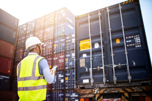 förman kontroll lastning behållare box från frakt lastfartyg för import export, förman kontroll industriella container frakt-lastfartyg. logistiska koncept. - hamn bildbanksfoton och bilder