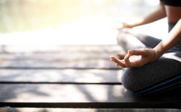 istock young women meditate while doing yoga in atmosphere peaceful. 1124339043