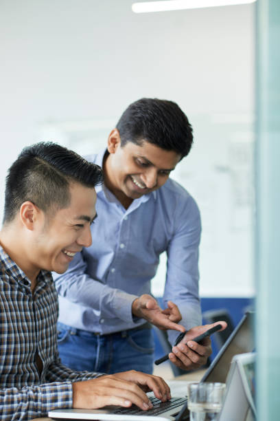 istock Sharing funny picture with coworker 1124339396