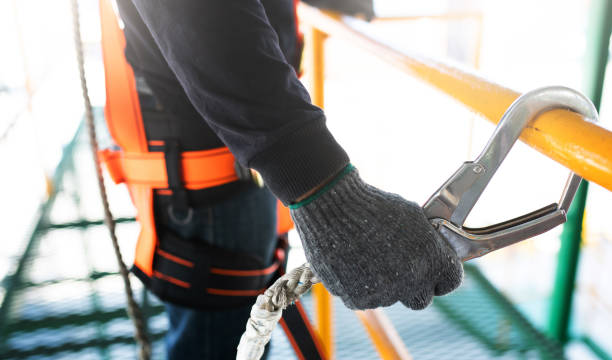 istock Construction worker wearing safety harness and safety line working on construction 1124339555