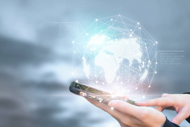 istock Businessman holding phone in hand with global connection concept. 1124339571