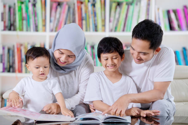 istock Asian family reading books in the library 1124340688