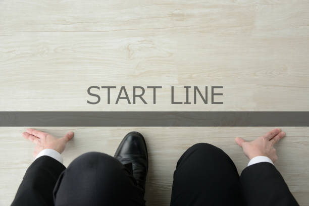 Business man ready for crouching start on starting line