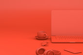Office desktop with Laptop, Red Background, Technology Concept.