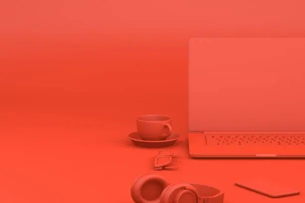 Photo of Office desktop with Laptop, Red Background, Technology Concept.