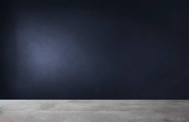 istock Dark blue wall in an empty room with a concrete floor 1124347921