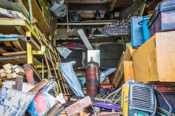 Photo of Big mess in an over stuffed suburban garage.