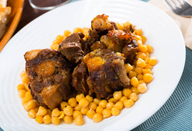 Braised oxtails with chickpeas on a white plate