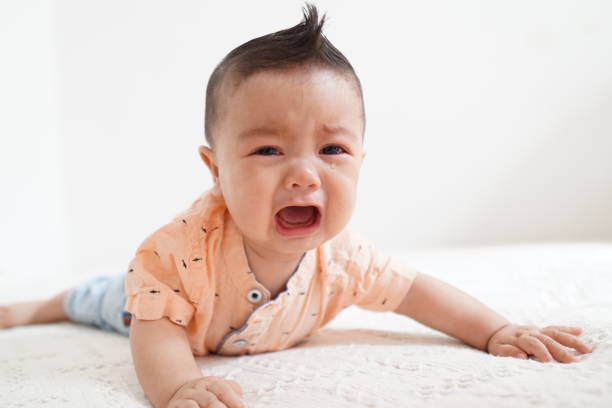Crying baby boy close-up picture with white background stock photo