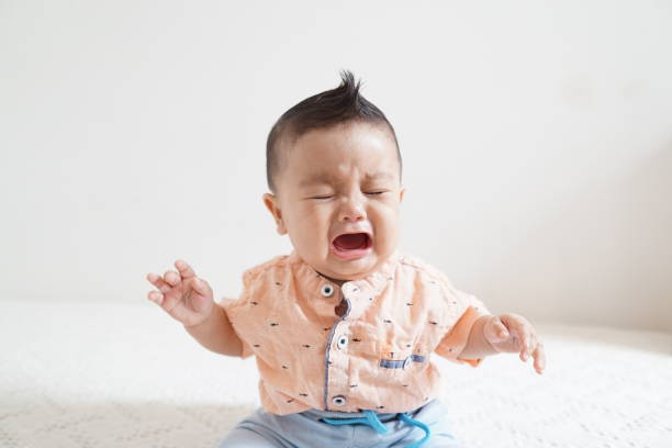 Crying baby boy close-up picture with white background stock photo