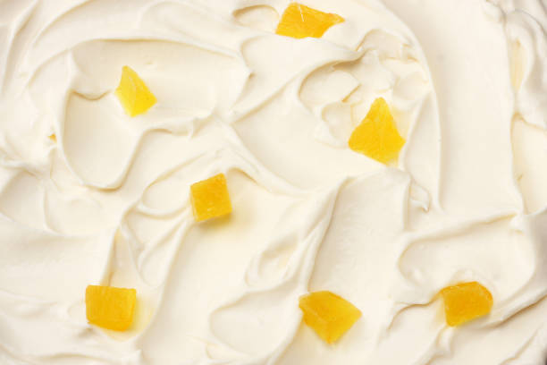 istock yogurt background with pineapple pieces. yogurt texture. top view 1124357104
